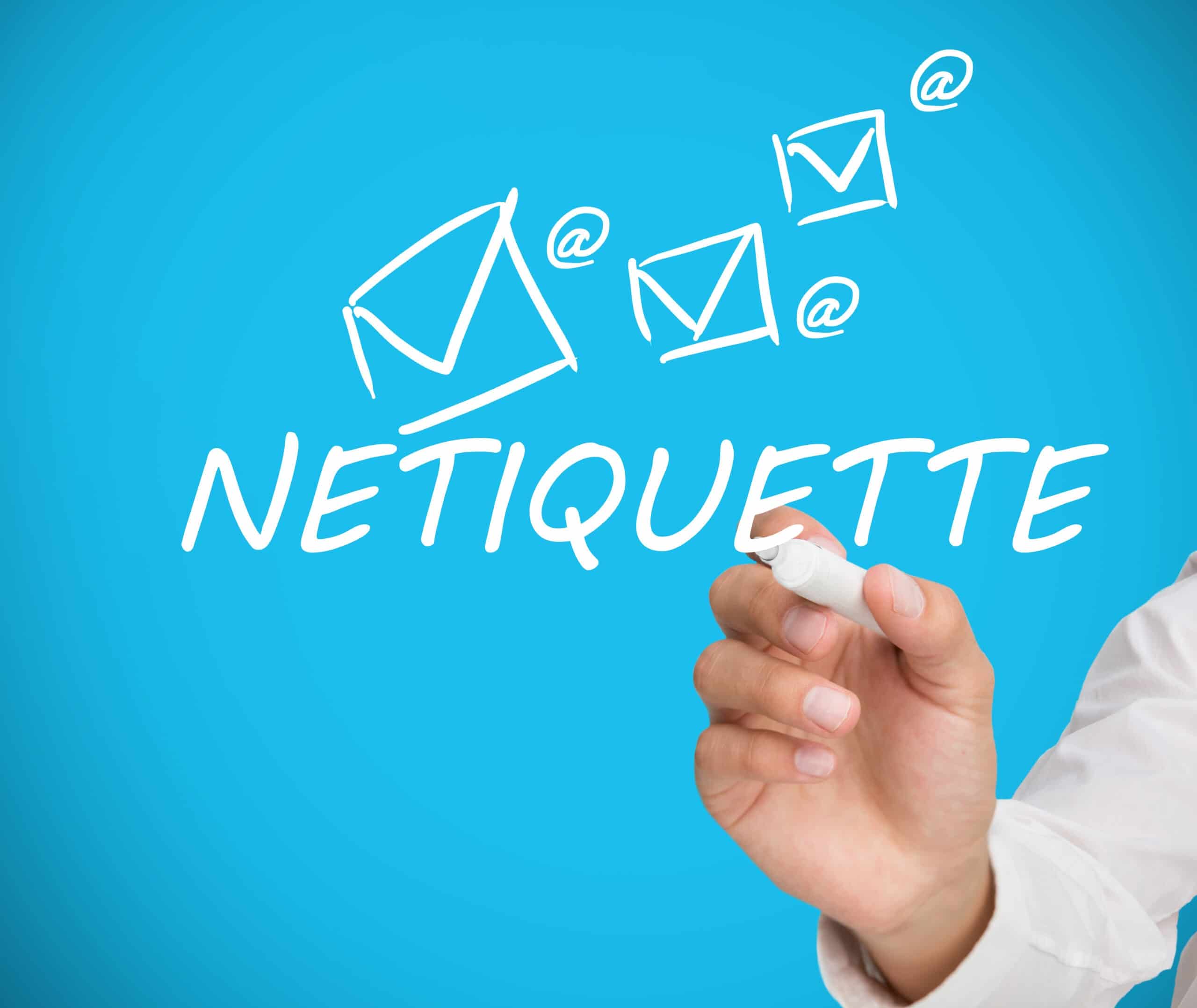 Businessman writing netiquette in white on blue backgorund